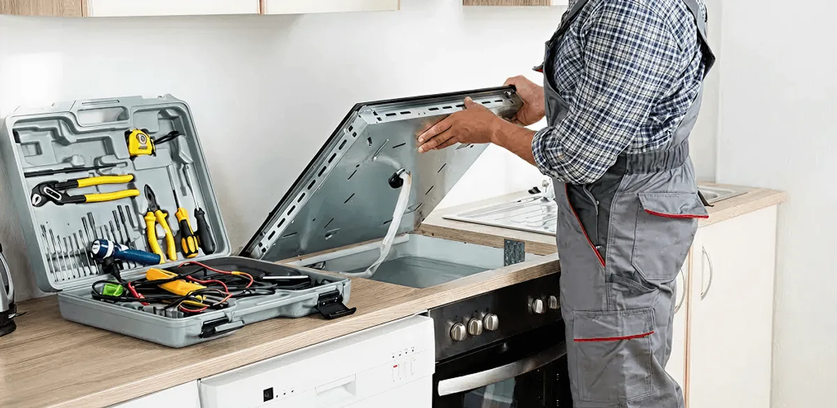 Handyman repairing a cooktop and checking wiring connections in Charlotte, NC