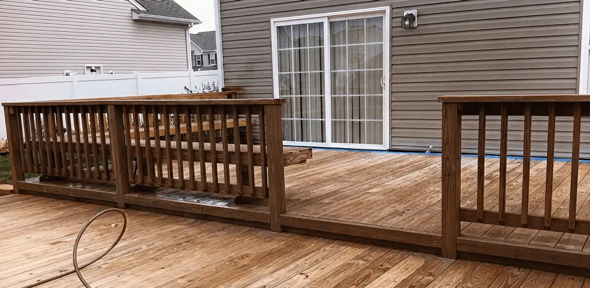 Deck sealing service protecting a backyard wood deck and railings in Charlotte, NC