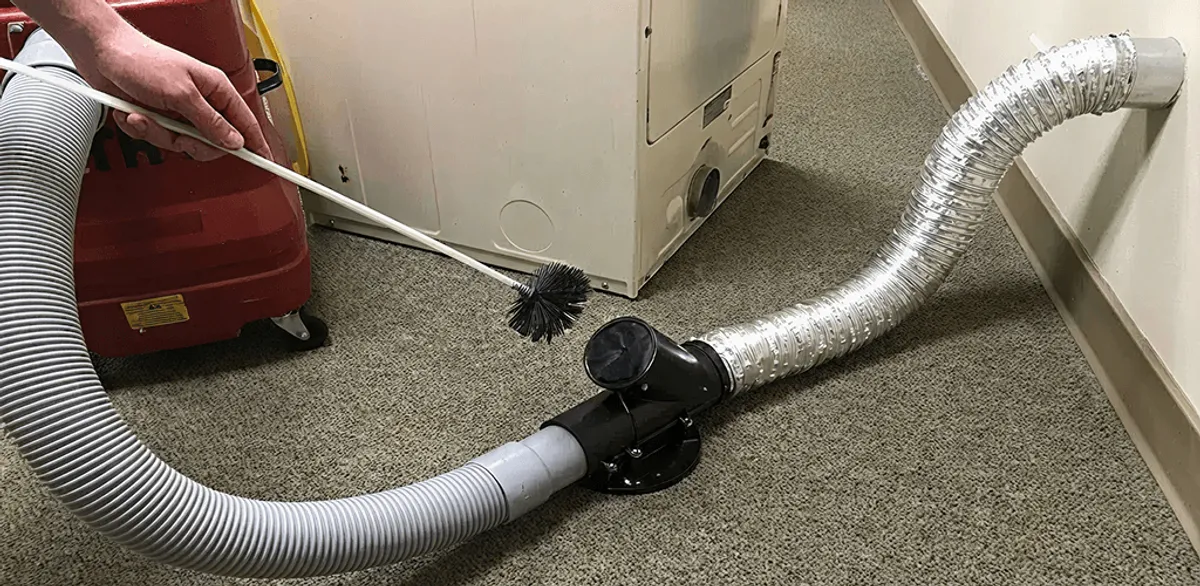 Dryer vent cleaning service removing lint from a dryer duct connection in Charlotte, NC