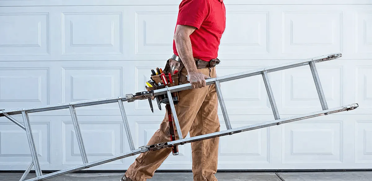Garage door repair technician arriving with tools and ladder in Charlotte, NC