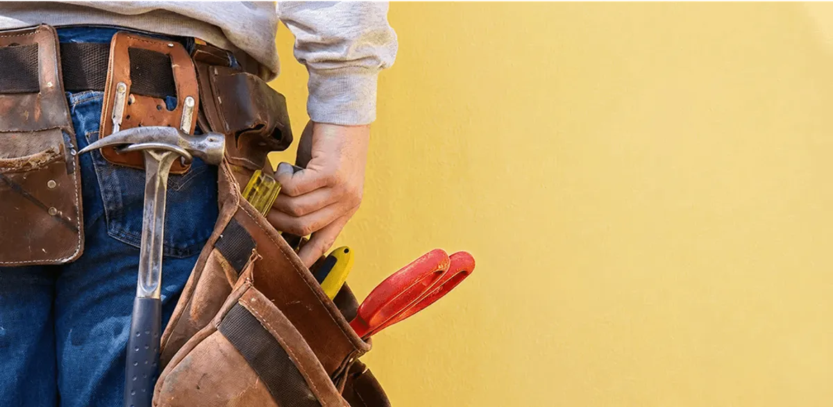 Handyman with tool belt ready for home repairs and maintenance in Charlotte, NC