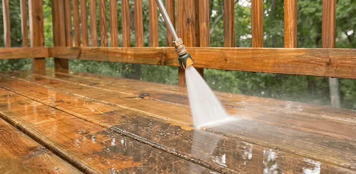 Pressure washing a wood deck to remove dirt and buildup in Charlotte, NC