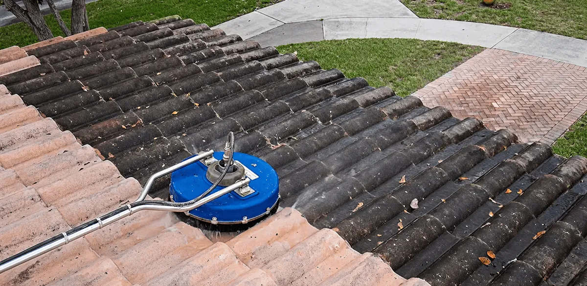 Roof pressure cleaning removing debris and buildup from roof tiles in Charlotte, NC