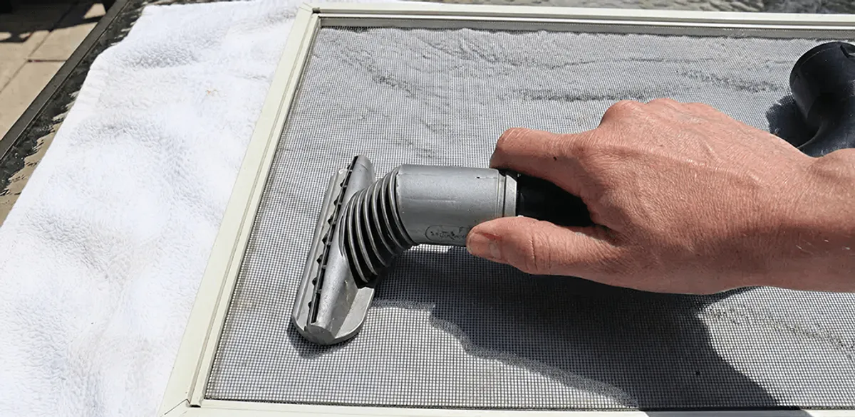 Window screen repair cleaning and fixing a damaged screen mesh in Charlotte, NC